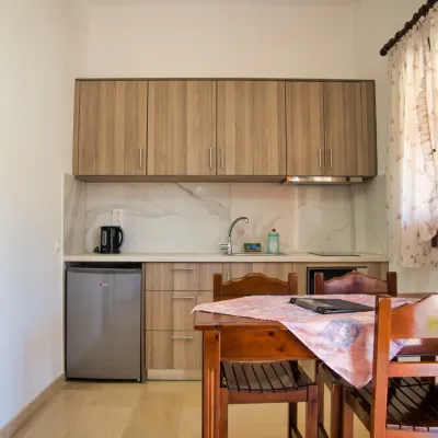 Kitchen and dining table in the two-bedroom apartment, Tria Adelphia, Arillas, Corfu