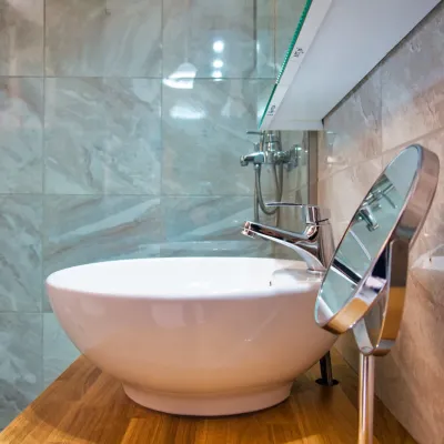 Designer vessel washbasin on a wood vanity, refurbished bathroom at Tria Adelphia, Arillas